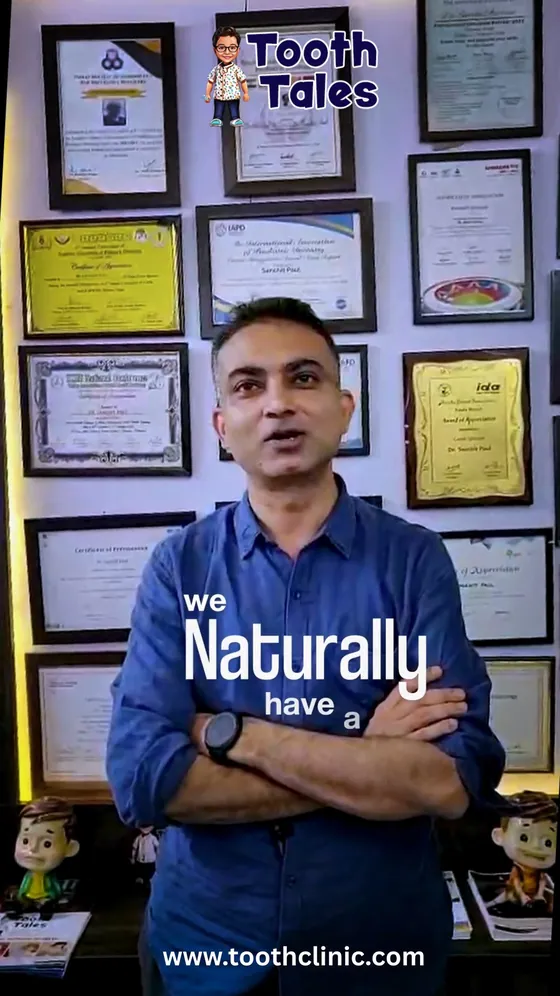 Dr. Sanchit Paul in front of the clinic's certificate wall