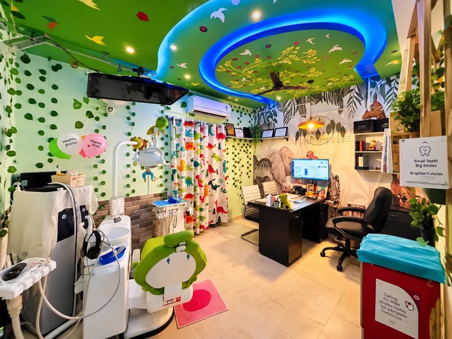 The Jungle treatment room at Tooth Tales, with leaves on the walls and a green ceiling