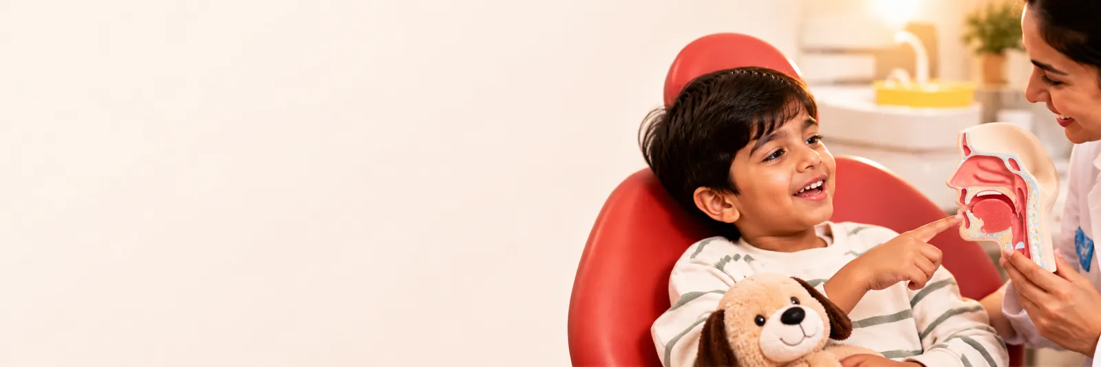 A boy pointing at a model of the nose and throat as the dentist explains mouth breathing